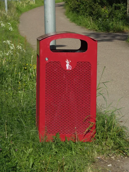 Red waste container aka Litter bin garbage bin trash bin or waste bin
