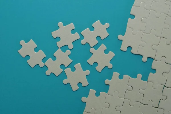 pieces of jigsaw puzzle on the blue background