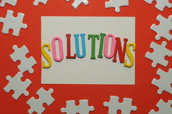 Solutions Word Jigsaw Puzzle Red Background — Stock Photo, Image