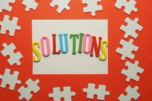 Solutions Word Jigsaw Puzzle Red Background — Stock Photo, Image