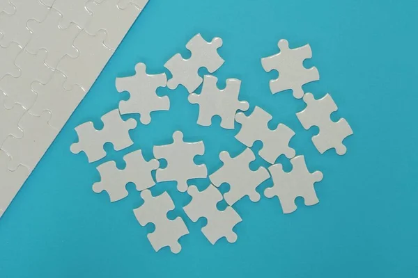 white jigsaw puzzle on the blue background