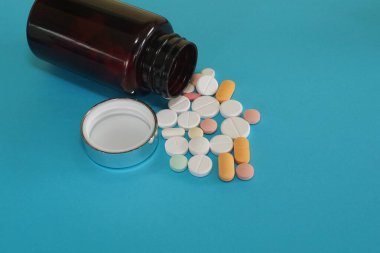 haplar ve şişe mavi arka planda