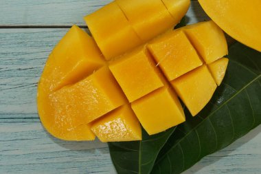 close up of chopped mango on the wooden background