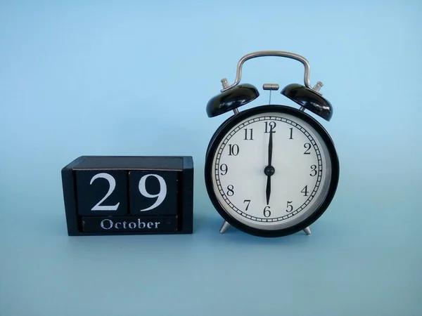 Reloj Despertador Aislado Sobre Fondo Azul Con Fecha Cubo Bloque —  Fotos de Stock