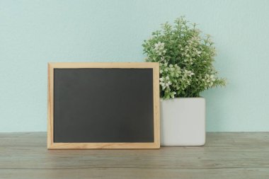 Tahta, çiçek ve kalemler masaya..