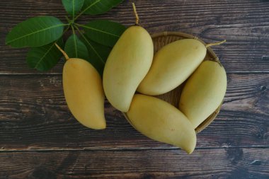 Ahşap arka planda sarı mango