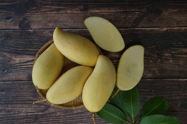 Ahşap arka planda sarı mango