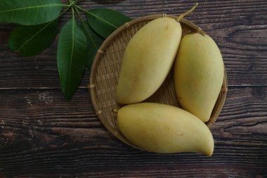 Ahşap arka planda sarı mango