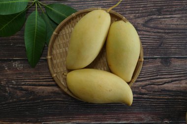 Ahşap arka planda sarı mango