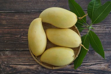 Ahşap arka planda sarı mango