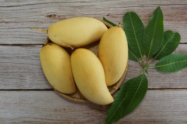 Ahşap arka planda sarı mango