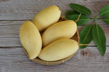 Ahşap arka planda sarı mango