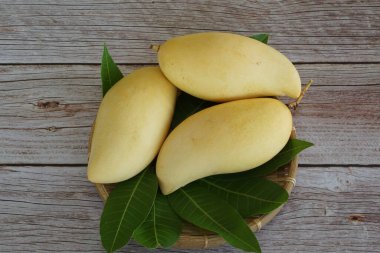 Ahşap arka planda sarı mango