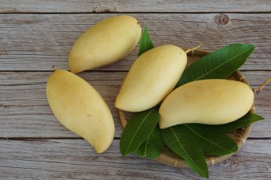 Ahşap arka planda sarı mango