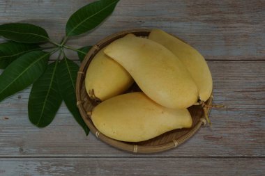 Ahşap arka planda sarı mango