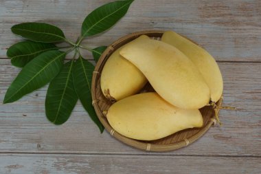 Ahşap arka planda sarı mango
