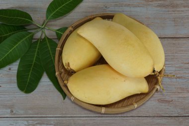 Ahşap arka planda sarı mango