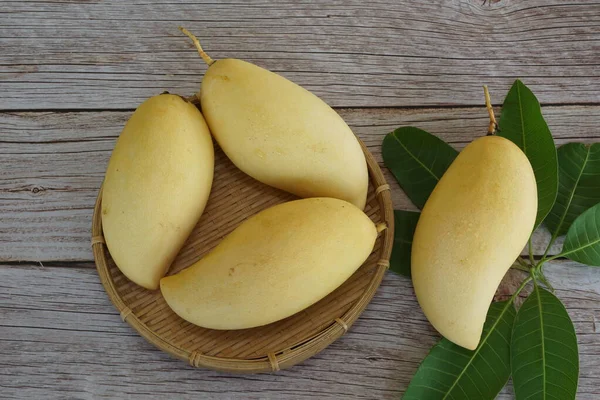 Ahşap arka planda sarı mango