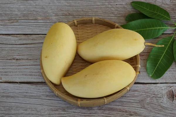 Ahşap arka planda sarı mango