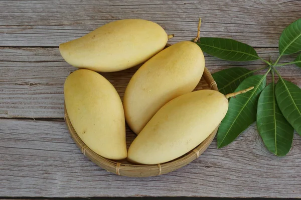 Ahşap arka planda sarı mango