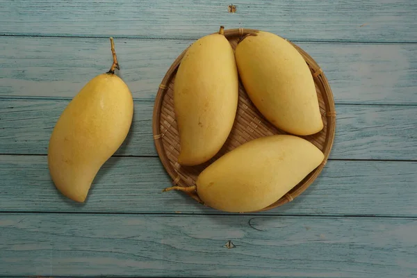 Ahşap arka planda sarı mango