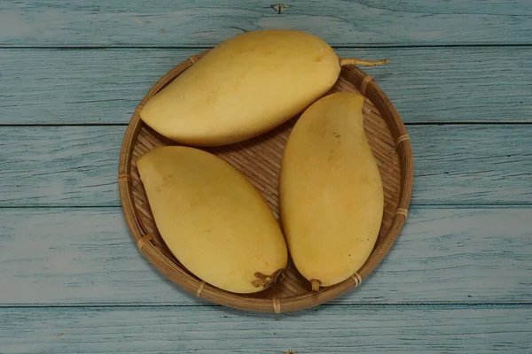 Ahşap arka planda sarı mango