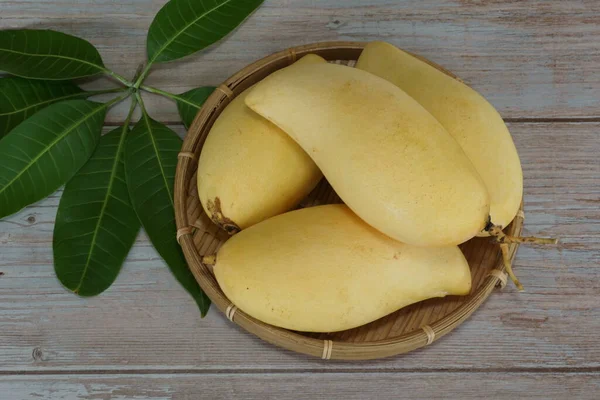 Ahşap arka planda sarı mango