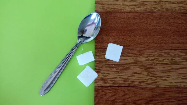 Spoon Sugar Cubes Green Brown Background — Stock Photo, Image