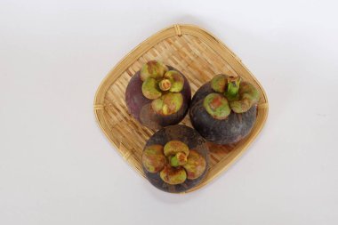 mangosteen fruits on the basket