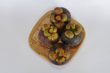 mangosteen fruits on the basket