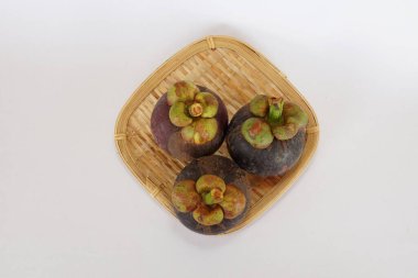 mangosteen fruits on the basket