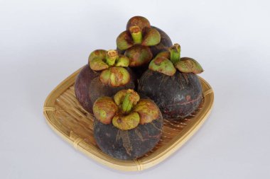 mangosteen fruits on the basket