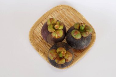 mangosteen fruits on the basket