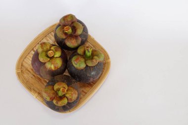 mangosteen fruits on the basket
