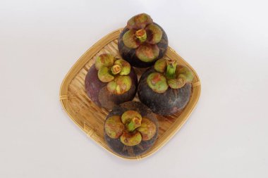 mangosteen fruits on the basket