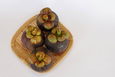 mangosteen fruits on the basket