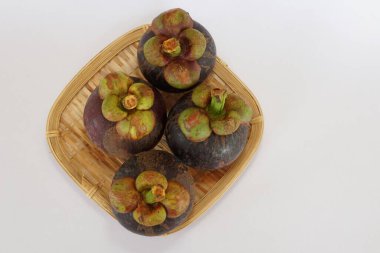 mangosteen fruits on the basket