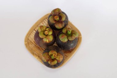 mangosteen fruits on the basket