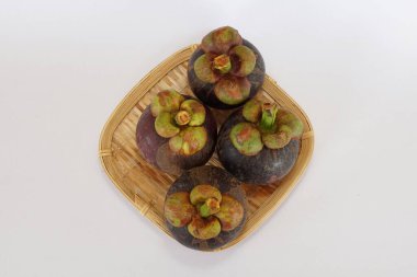mangosteen fruits on the basket