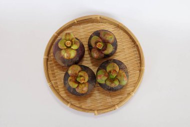 mangosteen fruits on the basket