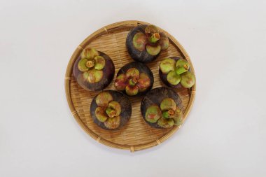 mangosteen fruits on the basket