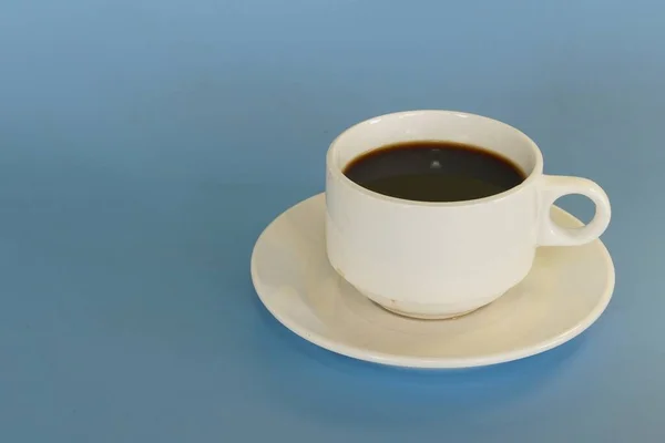a cup of coffee against blue background