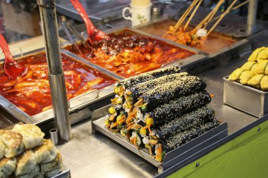 Gimbab, korean street food made from steamed rice and various other ingredients, rolled in dried seaweed sale in Busan, South Korea. Similar to Japanese sushi. clipart