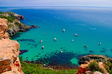 Bounty beach at Cape Fiolent in the Crimea. Sea lagoon with boats and yachts on a sunny summer day.