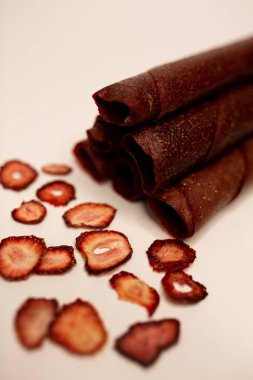 Meyve, marşmelov ve meyve cipsi masada.