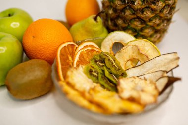 Meyve, marşmelov ve meyve cipsi masada.