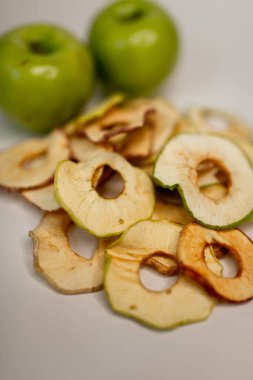 Meyve, marşmelov ve meyve cipsi masada.