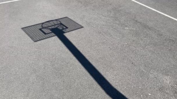 Schaduw, silhouet Basketbalring met het metalen bord op een schoolplein — Stockvideo