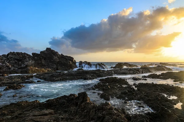 Nefes kesici bir gün doğumu Burgess Sahili 'nin engebeli kayalık manzarasını canlı renklerle boyuyor. Dalgalar kıyı şeridine çarpıyor. Altın ışık, Avustralya 'nın kıyı manzarasının vahşi güzelliklerini yansıtıyor..