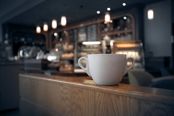 White cup of coffee at the cafe interior — Stock Photo, Image